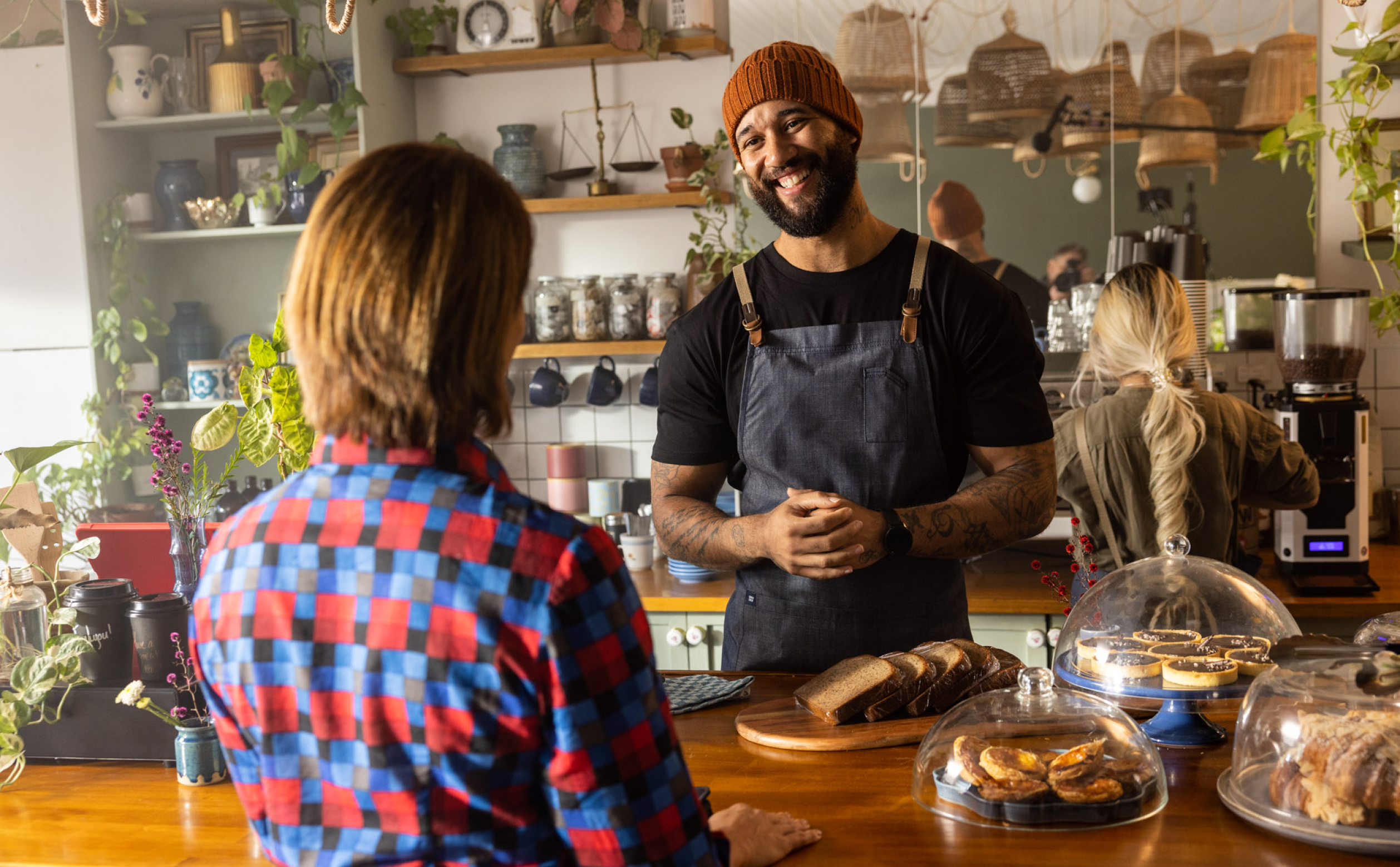 Man serving a woman in a coffee shop